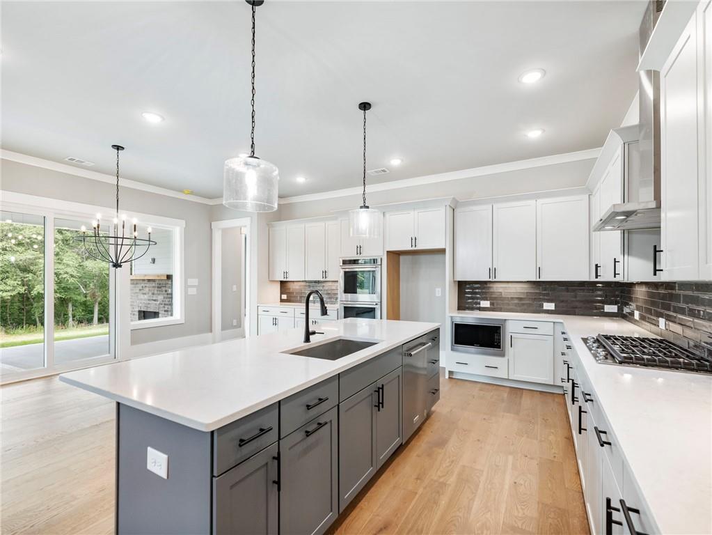 170 Ewing Way Dacula, GA 30019 - Photo 10 of 45 a large kitchen with kitchen island a sink stainless steel appliances and cabinets