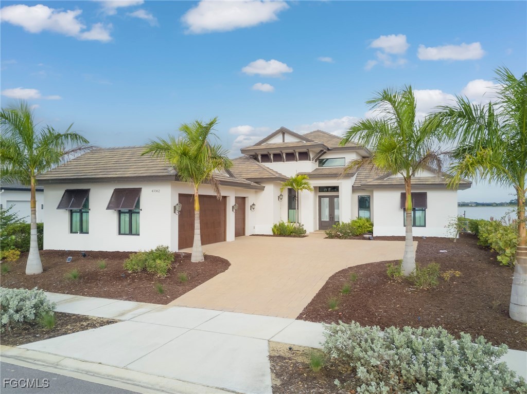 43362 Waterside Trail Punta Gorda, FL 33982 - Photo 1 of 50 a front view of a house with a yard and garage