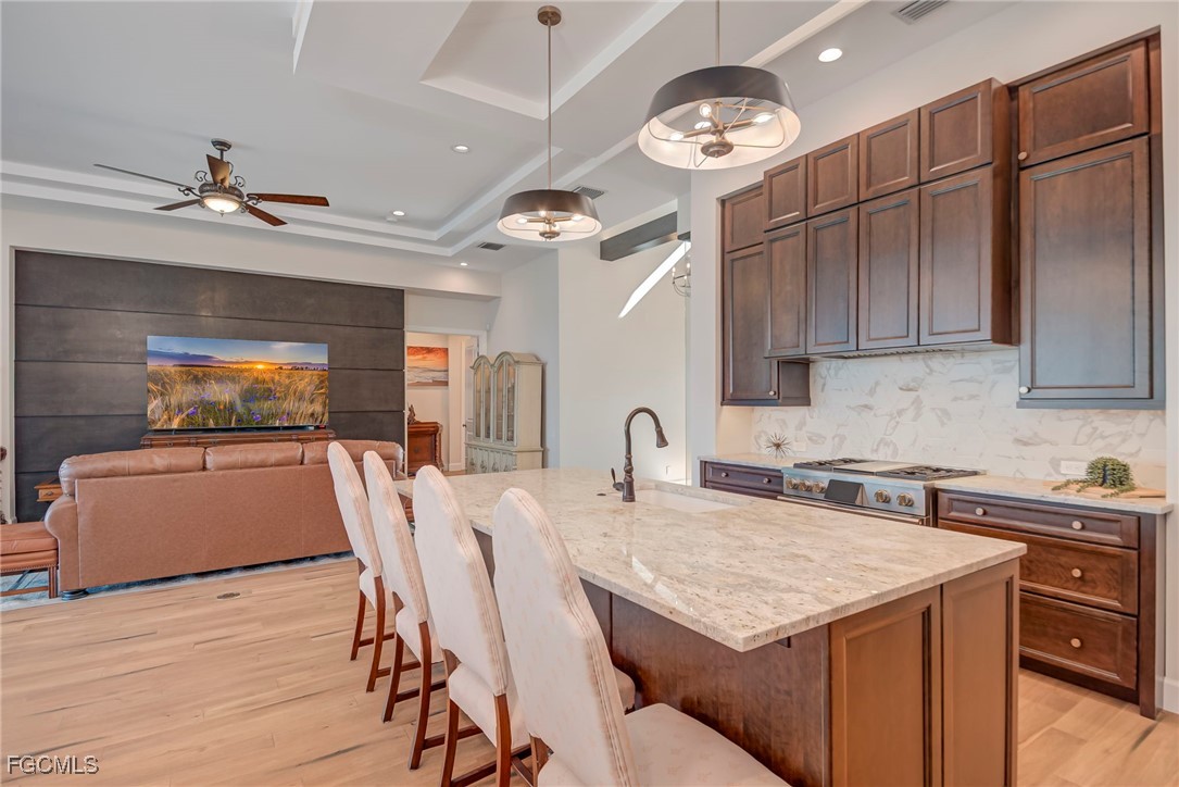 43362 Waterside Trail Punta Gorda, FL 33982 - Photo 12 of 50 a kitchen with a stove a sink a refrigerator dining table and chairs