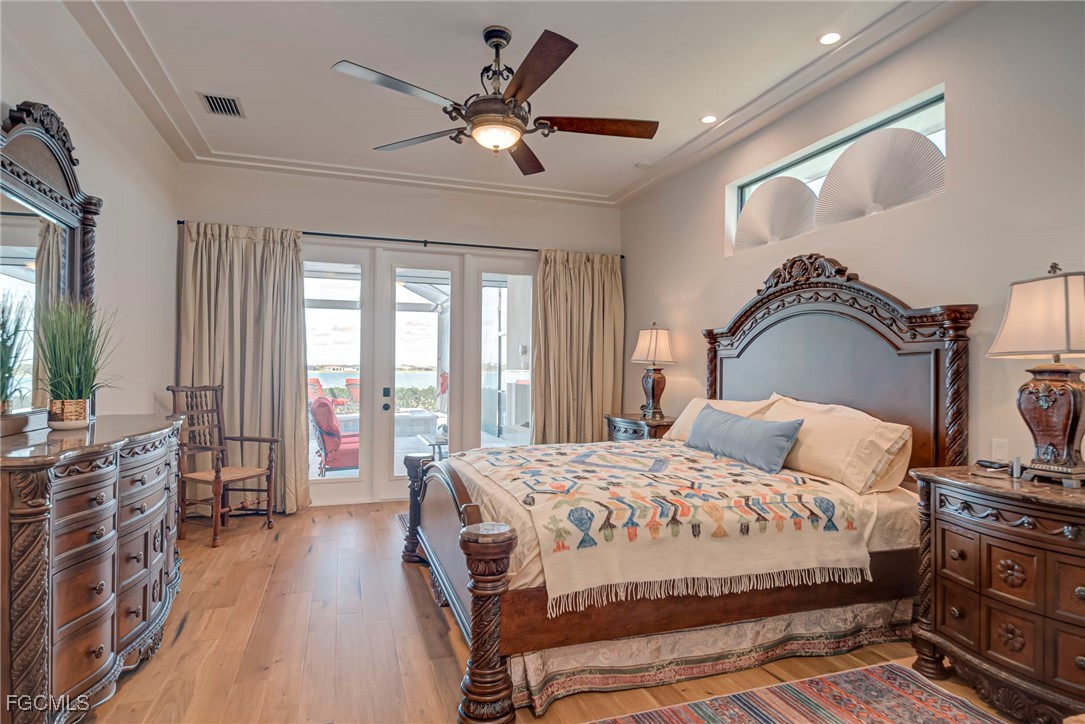 43362 Waterside Trail Punta Gorda, FL 33982 - Photo 16 of 50 a bedroom with a bed and a chandelier