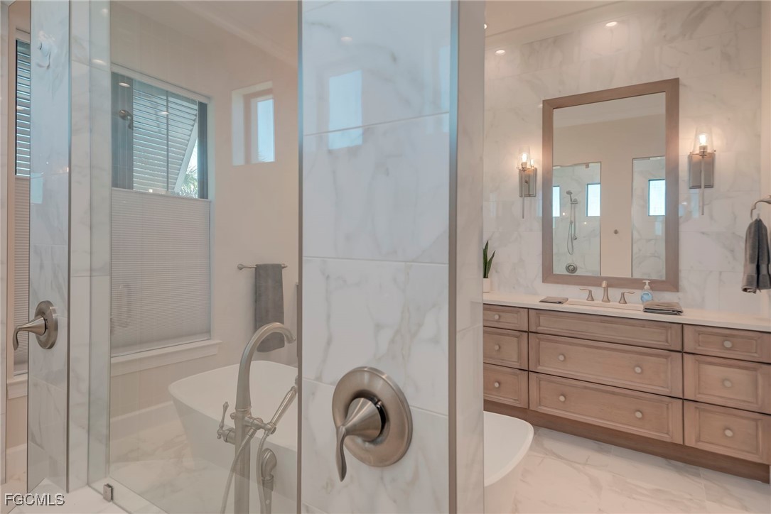 43362 Waterside Trail Punta Gorda, FL 33982 - Photo 19 of 50 a bathroom with a granite countertop sink a mirror and shower