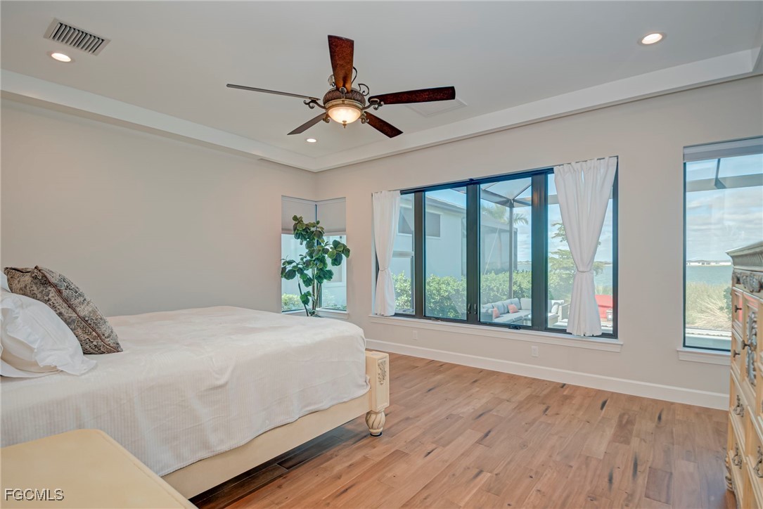 43362 Waterside Trail Punta Gorda, FL 33982 - Photo 21 of 50 a bedroom with a large bed and a large window