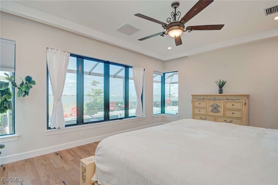 43362 Waterside Trail Punta Gorda, FL 33982 - Photo 22 of 50 a bedroom with a large bed and a large window