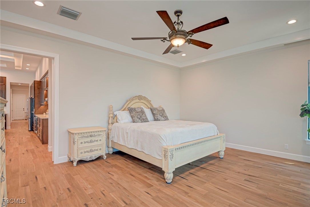 43362 Waterside Trail Punta Gorda, FL 33982 - Photo 23 of 50 a view of a bedroom with wooden floor and ceiling fan