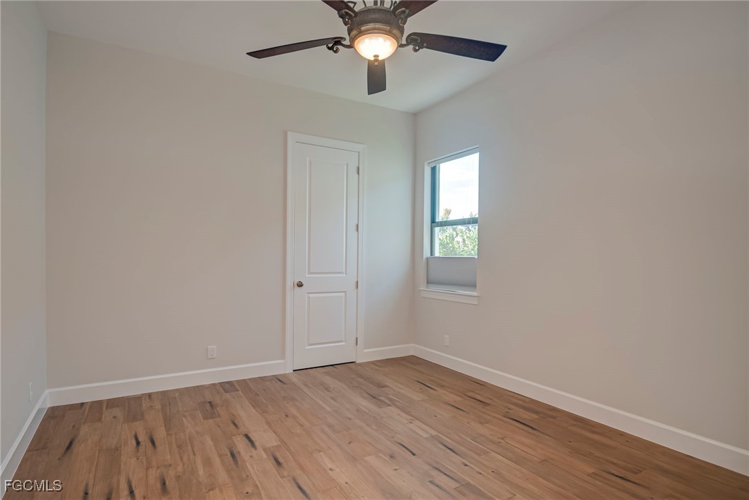 43362 Waterside Trail Punta Gorda, FL 33982 - Photo 25 of 50 wooden floor in an empty room with a window