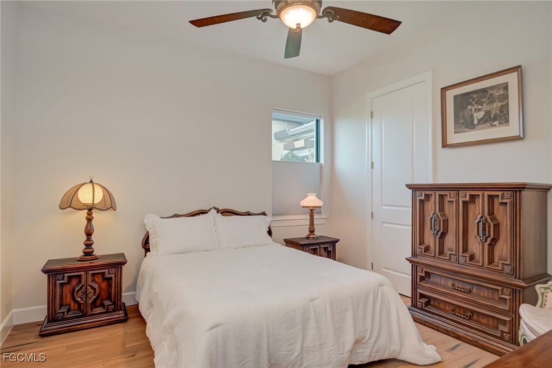 43362 Waterside Trail Punta Gorda, FL 33982 - Photo 27 of 50 a bedroom with a bed and wooden floor