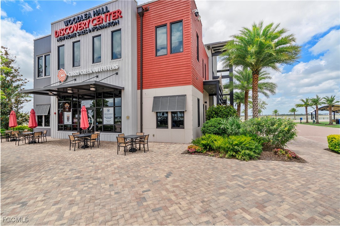 43362 Waterside Trail Punta Gorda, FL 33982 - Photo 46 of 50 a view of a brick building with many windows and a table