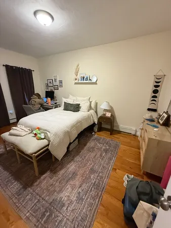 a bedroom with bed and a window