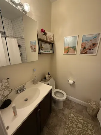 a bathroom with a sink mirror and toilet