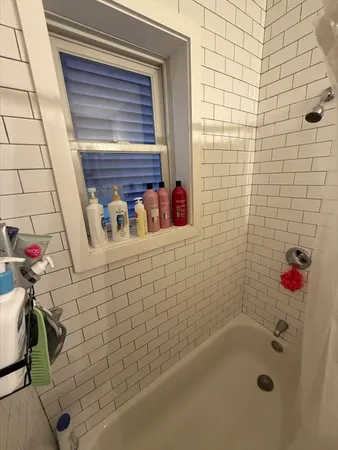 a bathroom with a bathtub and shower