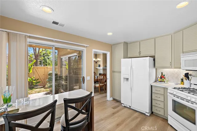 a view of a chair and table in the back yard