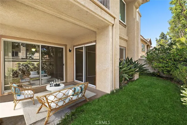 a view of a house with brick walls and a yard with plants