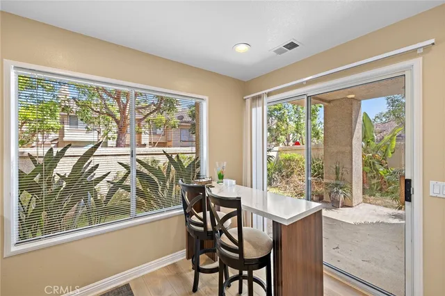 a bedroom with a bed and dresser with mirror