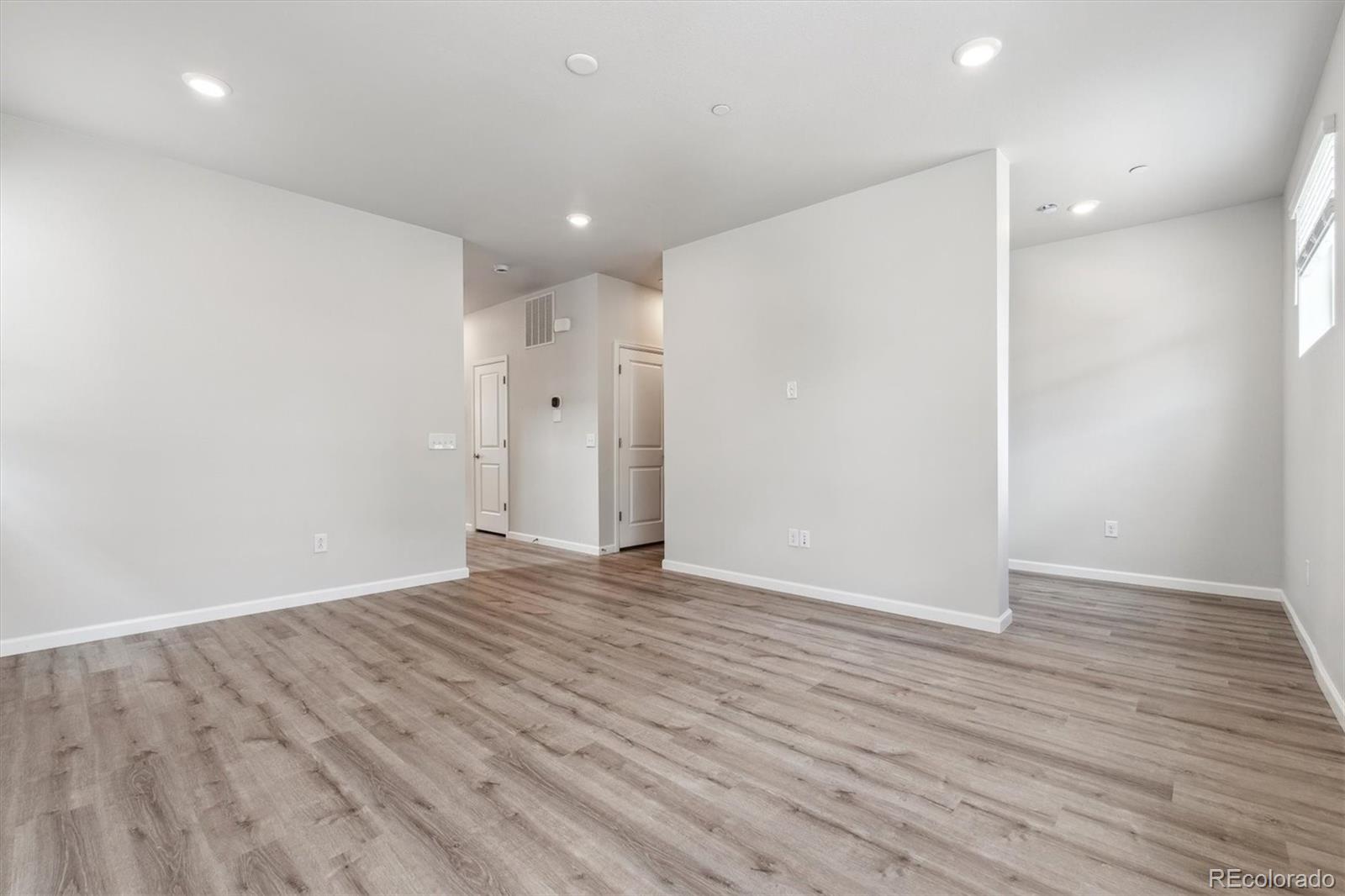 465 Interlocken Boulevard, Unit 101 Broomfield, CO 80021 - Photo 5 of 17 an empty room with wooden floor and natural light