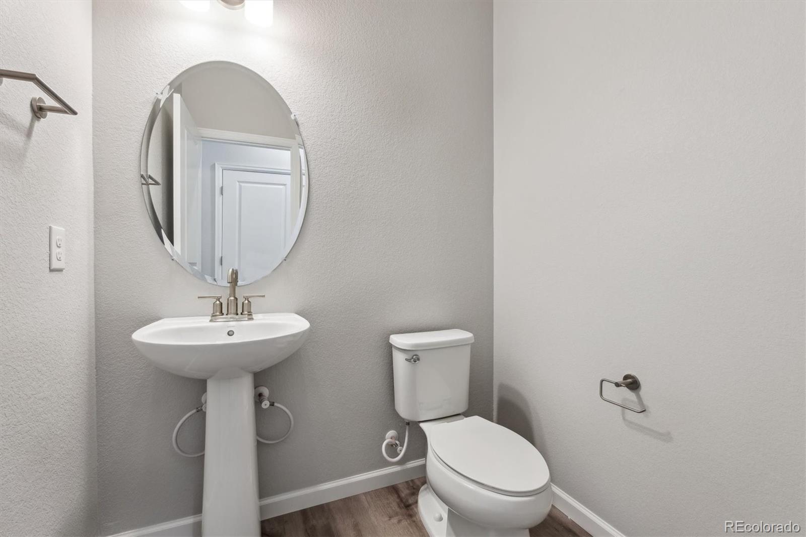 465 Interlocken Boulevard, Unit 101 Broomfield, CO 80021 - Photo 6 of 17 a bathroom with a toilet a sink and a mirror