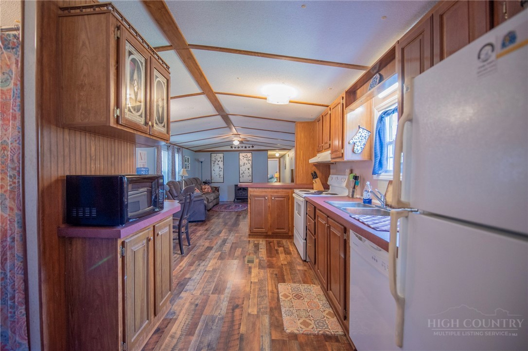 1848 West Mill Creek Road Warrensville, NC 28693 - Photo 24 of 50 a kitchen with stainless steel appliances a stove a sink and a refrigerator