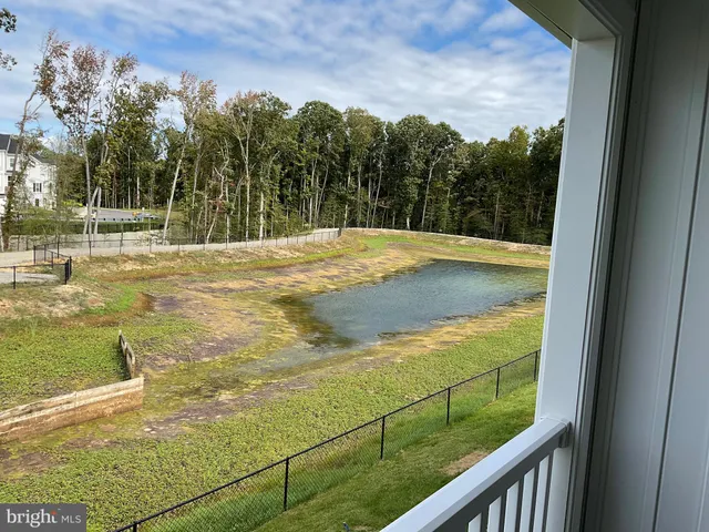 an empty room and a bathroom with a sink