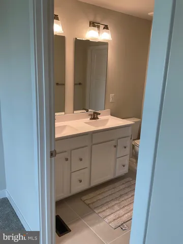 a bathroom with a double vanity sink and a mirror