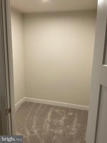 a bathroom with a granite countertop bathtub shower sink vanity and toilet