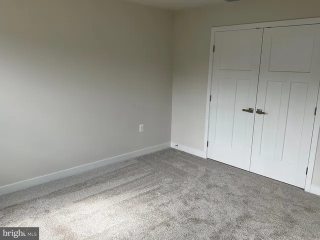 a view of an empty room and entryway