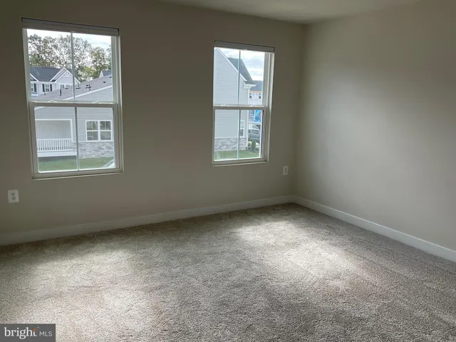 a kitchen with a refrigerator and white cabinets