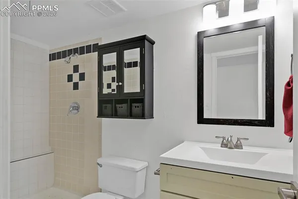a view of an empty room with wooden roof and stairs