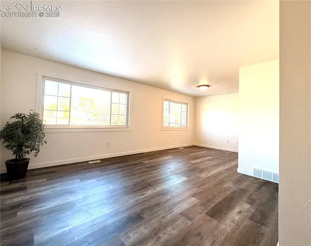 a front view of a house with a yard covered with snow in front of house