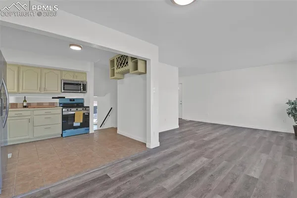 a view of a room with wooden floor and table