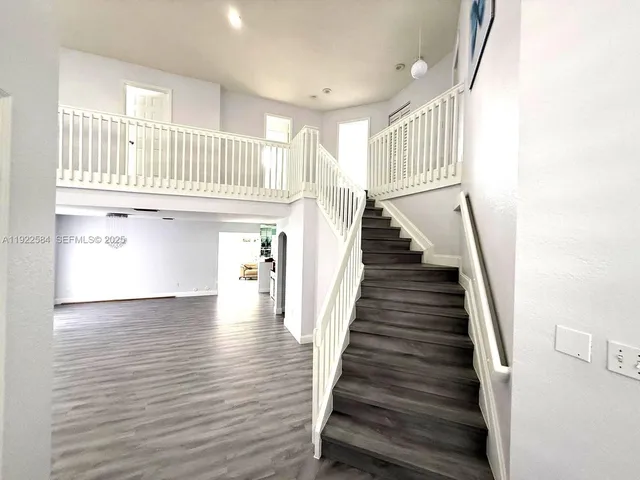 a view of entryway and hall with wooden floor