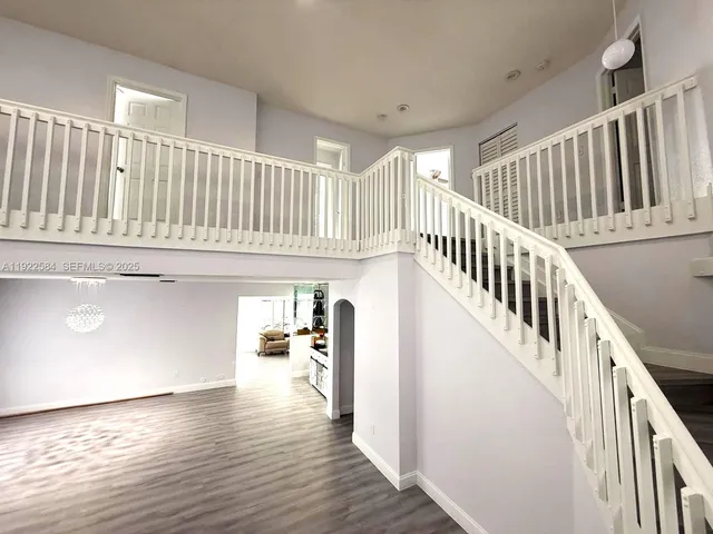 a view of staircase with wooden floor and a window