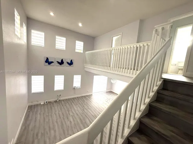 a view of entryway and hall with wooden floor