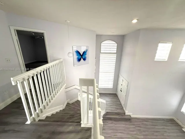 a view of entryway with wooden floor and stairs