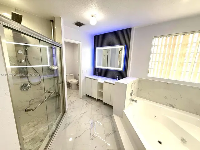 a bathroom with a bathtub and a sink