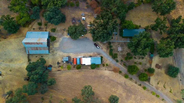 an aerial view of a house with yard and lake view