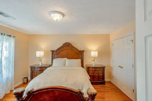 a bedroom with a bed and a lamp