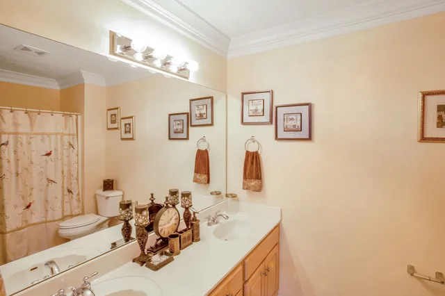 a bathroom with a sink vanity tub and a mirror