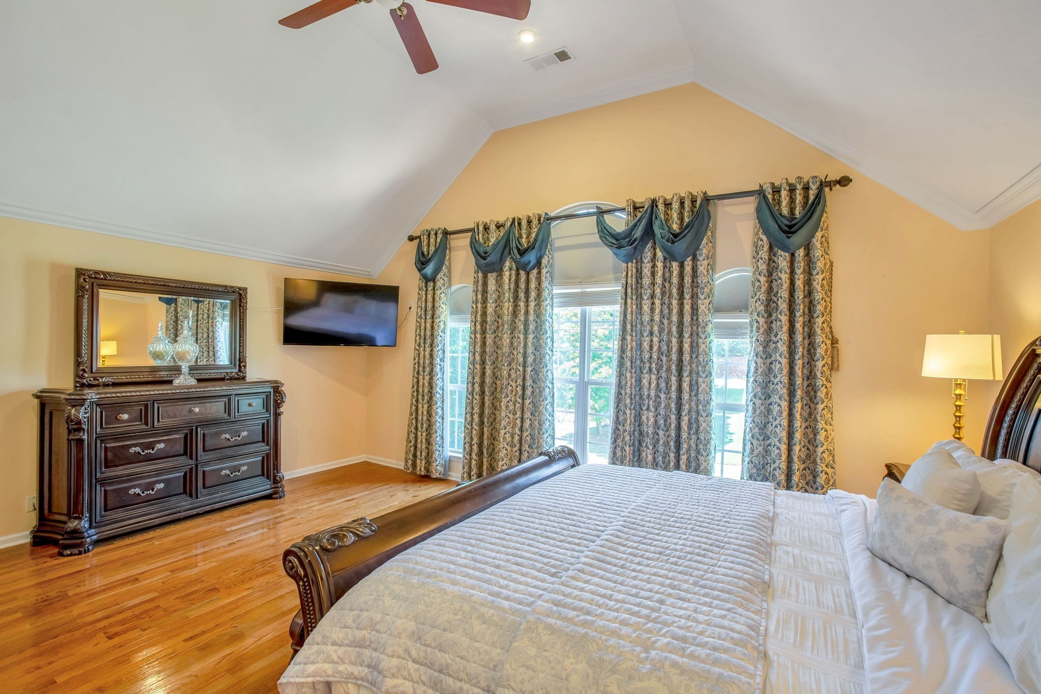 7344 Campton Road Nashville, TN 37211 - Photo 8 of 18 a bedroom with a large bed and a flat tv screen on dresser