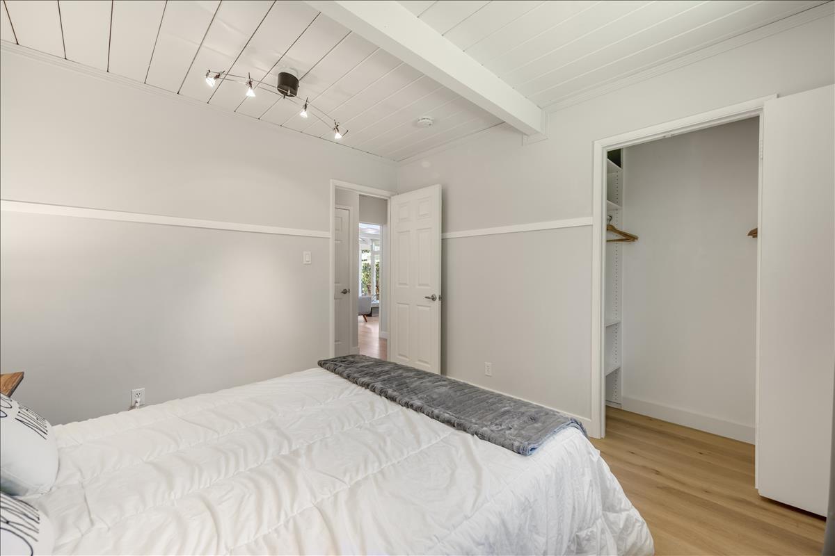 524 Thompson Avenue Mountain View, CA 94043 - Photo 23 of 34 a bedroom with a bed and wooden floor