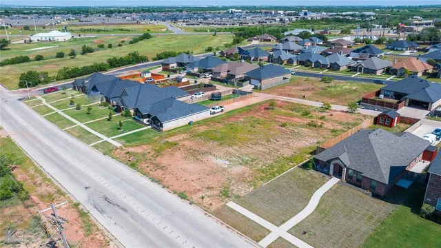 an aerial view of a house with a swimming pool yard and outdoor seating