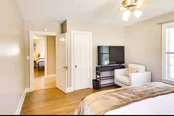 a bedroom with a bed and a chandelier