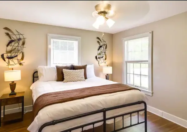 a bedroom with a large bed and a window