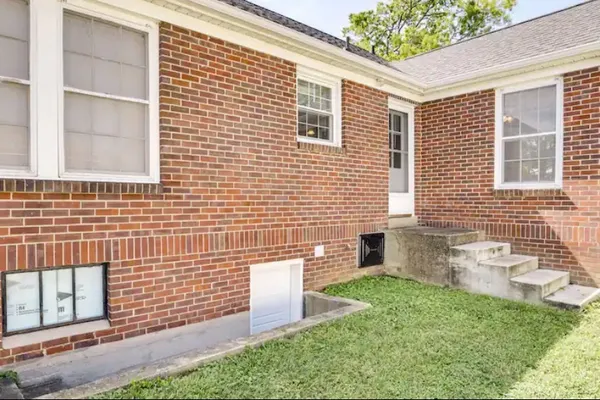a view of a house with a yard and sitting area