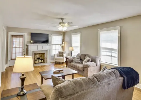a living room with furniture fireplace and a flat screen tv