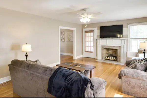 a living room with furniture flat screen tv and a fireplace