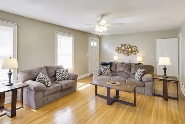 a living room with furniture and a wooden floor