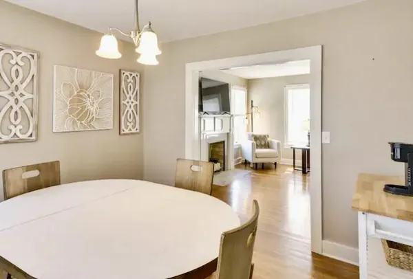 a spacious bedroom with a bed a chandelier and flat screen tv