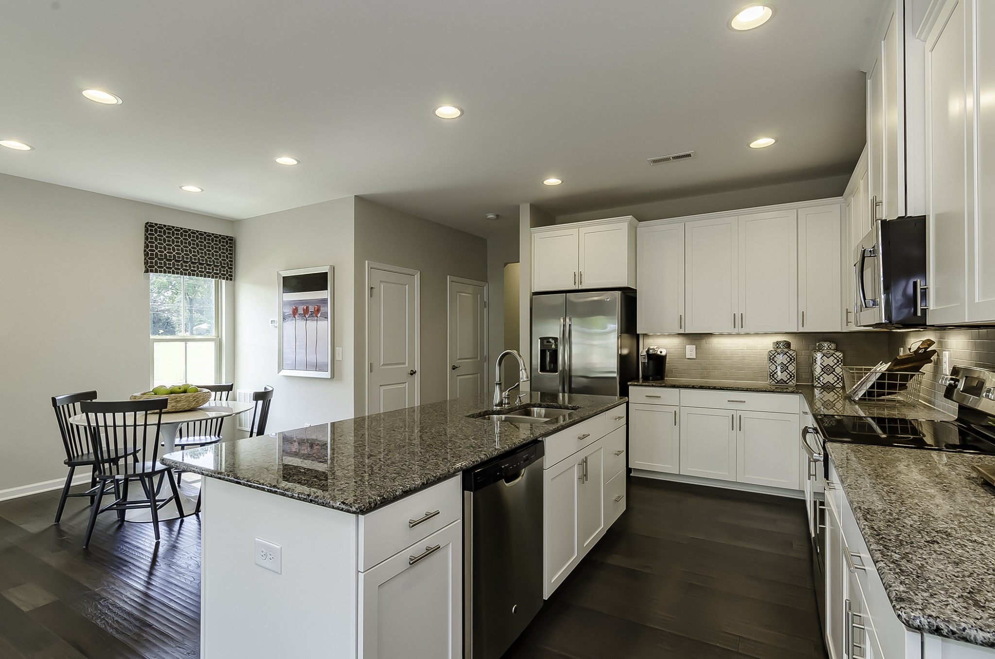 116 Keelon Gap Road Spring Hill, TN 37174 - Photo 2 of 10 a kitchen with sink cabinets and dining table