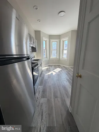a view of a livingroom with wooden floor and a window