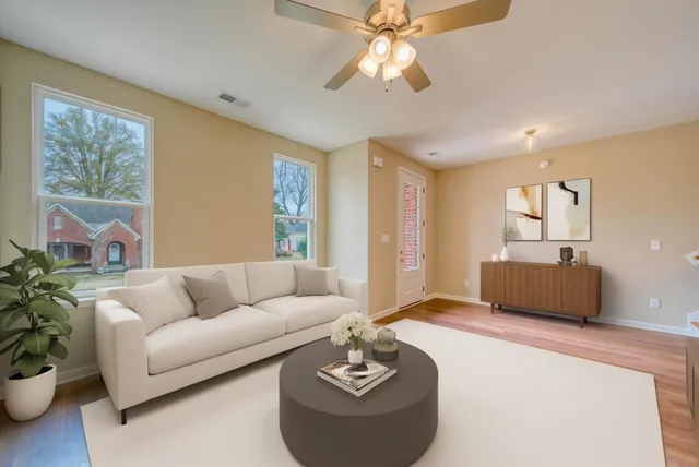 a living room with furniture and a large window