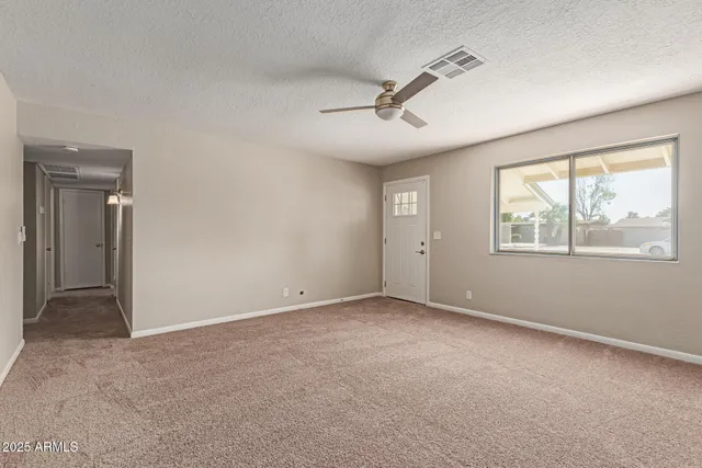a view of an empty room with a window